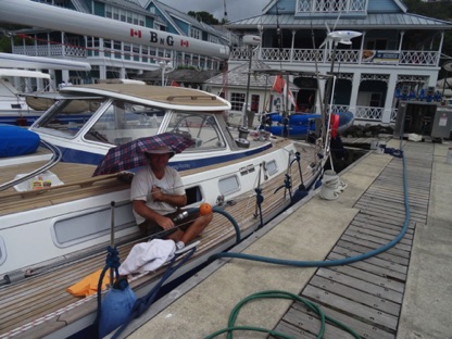 Adding fuel in sunny Marigot Bay Adding fuel in sunny Marigot Bay